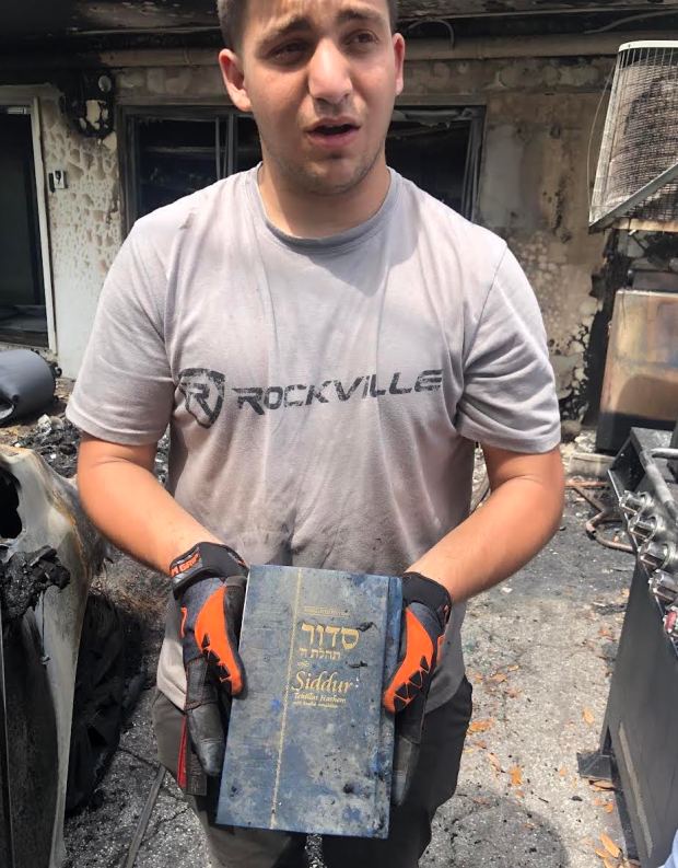 The Siddur that remained intact in the rabbi's burnt out van.Photo courtesy of Las Olas Chabad Jewish Center