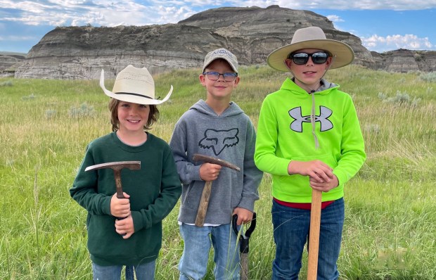 From left, Jessin Fisher, Liam Fisher and Kaiden Madsen are the young fossil hunters who spotted a large, fossilized leg bone during a walk on public lands in North Dakota. Their story is told in the documentary "T. Rex" playing at the IMAX theater in the Museum of Discovery & Science in Fort Lauderdale. (Sam Fisher/Courtesy)