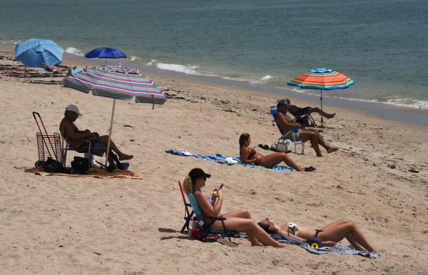 Sun bathers on Boynton Beach Tuesday morning.