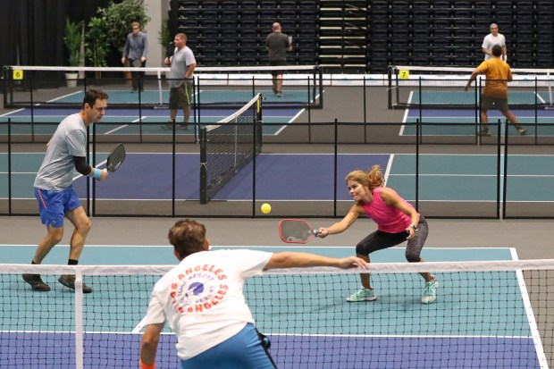 This is an image of people playing pickleball indoors in Coconut Creek.