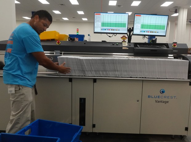 A worker prepares mail ballots on Tuesday, July 16, 2024 at the new Broward County Supervisor of Elections headquarters in Fort Lauderdale. (Joe Cavaretta/South Florida Sun Sentinel)