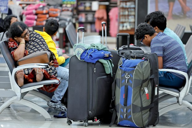 Travelers wait in Terminal 2 at Fort Lauderdale-Hollywood International Airport on Friday, July 19, 2024. A Microsoft 365 update affected users of the cybersecurity firm CrowdStrike, causing massive outages and delays at airports worldwide. (Amy Beth Bennett / Sun Sentinel)