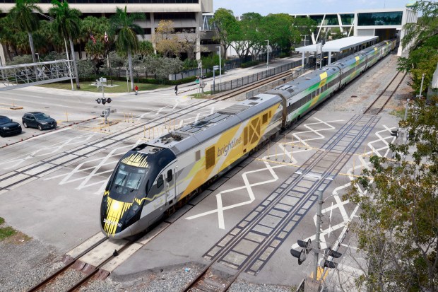 A southbound Brightline train at Broward Blvd. near the Transit terminal downtown, Fort Lauderdale, on Thursday, March 14, 2024. The Broward County Metropolitan Organization won $1.5 million in U.S. DOT money to build tunnels at five points along the rail line that carries FEC freight trains and Brightline's speedy passenger trains and eventually, local commuter trains. The cash outlay from the Biden Administration is part of a national program dispensing $3.3 billion for 132 projects aimed at lower income, disadvantaged people. (Mike Stocker/South Florida Sun Sentinel)