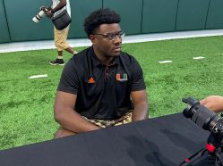 Hurricanes defensive lineman Justin Scott speaks to reporters at Miami's media day on July 30. Scott, a former five-star recruit, is looking to carve out a role on Miami's defense this season (Adam Lichtenstein / South Florida Sun Sentinel).