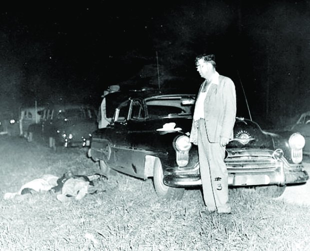 In an image provided by the State Archives of Florida, in 1951, Samuel Shepherd and Walter Irvin were shot by Sheriff Willis McCall, standing, while they were being taken to a pretrial hearing. Shepherd died and Irvin survived. Four Black men wrongly charged with raping a white woman more than 70 years ago in Florida were exonerated on Monday, Nov. 22, 2021, bringing an end to a saga that has shadowed their families for decades. (State Archives of Florida via The New York Times)