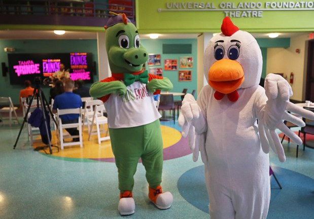 Orlando Fringe's Fringezilla and Frankie the Fringe Chicken from Tampa Fringe dance at a media event celebrating World Fringe Day on July 11 at Orlando Family Stage. (Ricardo Ramirez Buxeda/ Orlando Sentinel)