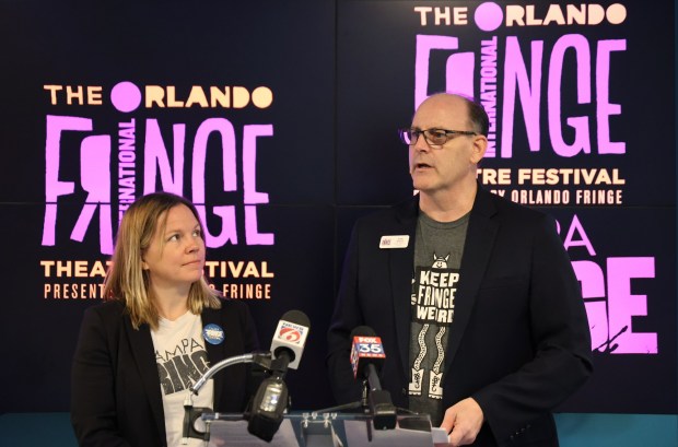 Tampa Fringe Festival Producer Trish Parry looks as Orlando Fringe Festival Interim Executive Director Scott Galbraith speaks during a media event to celebrate World Fringe Day and draw attention to funding cuts to the arts in Florida. (Ricardo Ramirez Buxeda/ Orlando Sentinel)