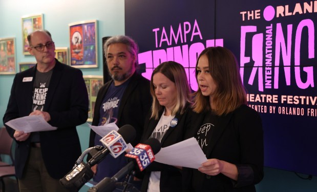 Orlando Fringe Festival Interim Executive Director Scott Galbraith (from left), Tampa Fringe Festival Director William Glenn, Tampa Fringe Festival Producer Trish Parry, and Orlando Fringe Festival Producer Tempestt Halstead read excerpts from an open letter to Gov. Ron DeSantis asking for state funding of arts grants to be restored. (Ricardo Ramirez Buxeda/ Orlando Sentinel)