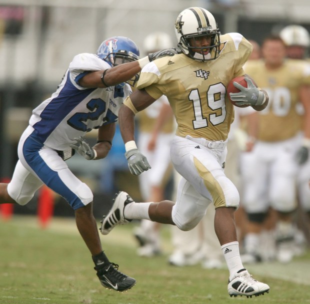 UCF punt returner Joe Burnett (19) runs away from Memphis defensive back Michael Grandberry (27) during the first half of their game at Bright House Networks Stadium in Orlando on Sept. 22, 2007. (Gary W. Green/Orlando Sentinel)