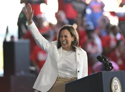 Vice President Kamala Harris smiles and waves at a campaign rally